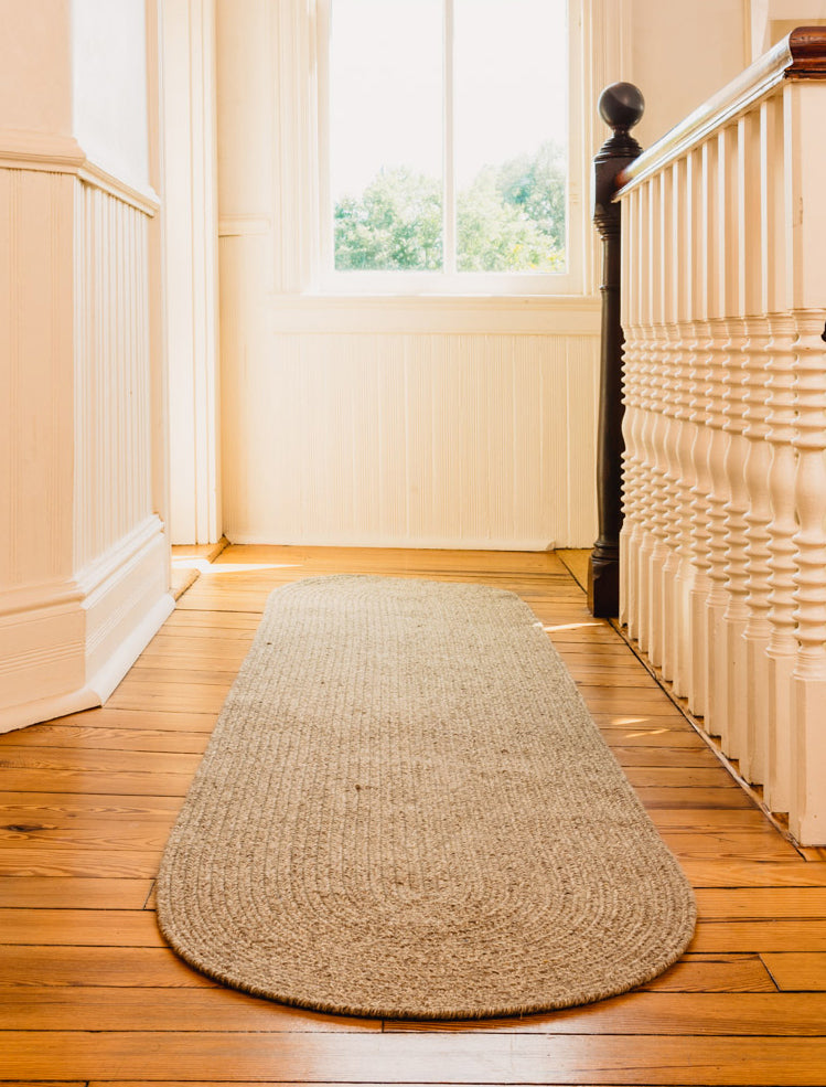 Oval, dark grey runner made with sustainable wool in the USA