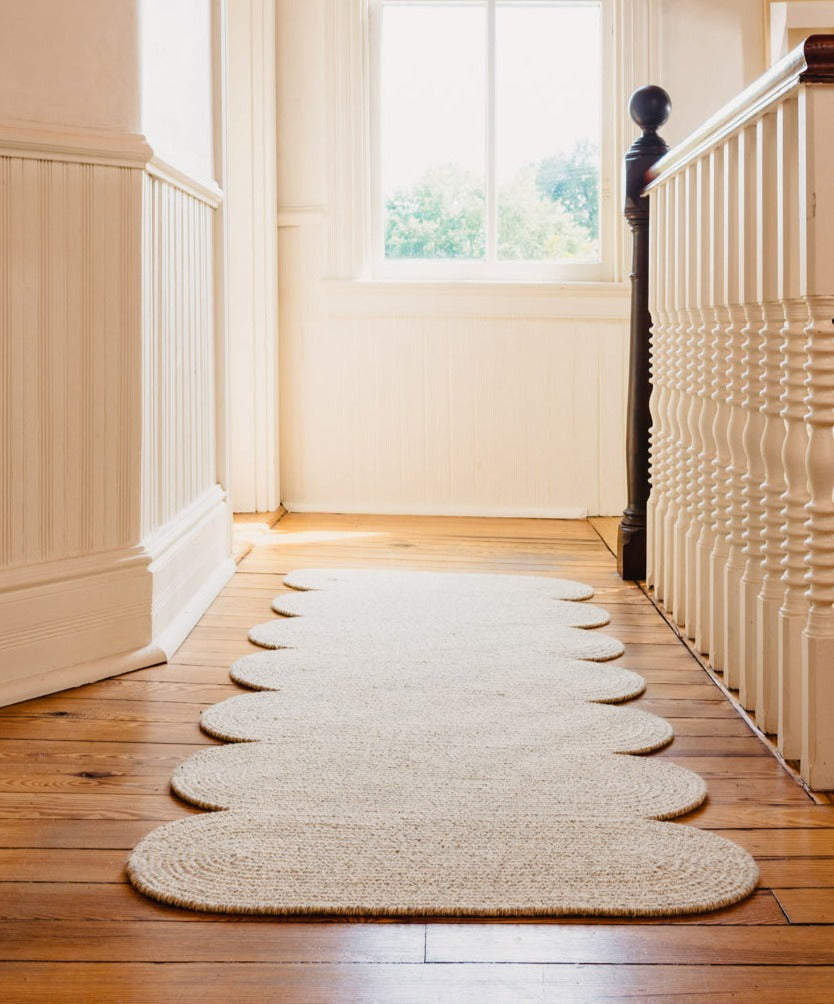 Light grey sustainable wool area rug in curvy shape